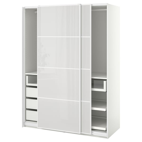 A white ikea PAX wardrobe with sliding doors and drawers. It a sleek, modern design with a glass front on some drawers.
