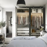 Modern walk-in closet with PAX wardrobes, mirrors, and storage.