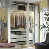 Well-organized wardrobe with clothes, drawers, and lighting; includes mesh basket and hanging space