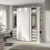 Modern bedroom with white PAX wardrobe, mirrored, lit, office desk, chair, lamp.