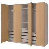 A wooden PAX wardrobe with open doors displaying shelves, drawers, and compartments.