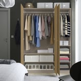 Wardrobe with clothes and bed; wooden, open