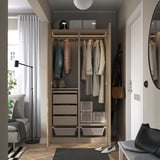 Open wardrobe showcasing coats, drawers, and storage boxes; slow-closing hinges and adjustable feet.