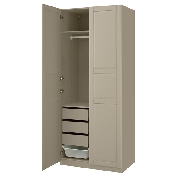 A beige PAX wardrobe with open doors, featuring drawers and a hanging rail inside.