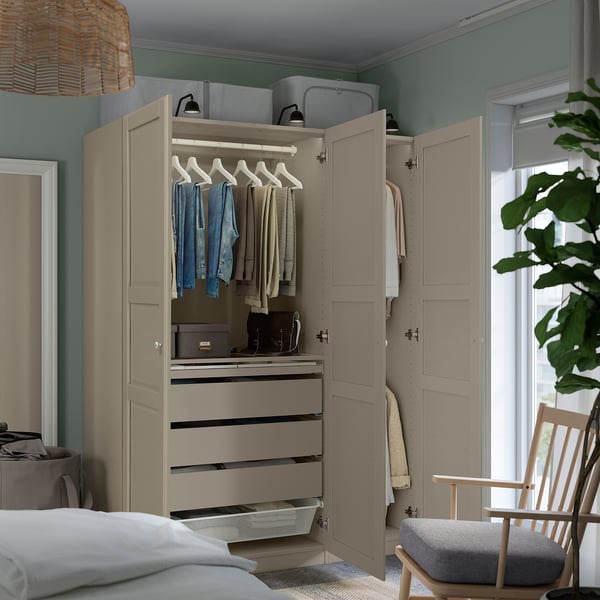 Bedroom closet with clothes, drawers, and shelves. Wardrobe has hanging space, adjustable feet, and slow-closing doors.