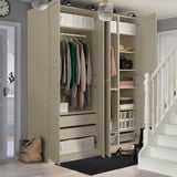 Beige wardrobe with clothes, shelves, lights, baskets.