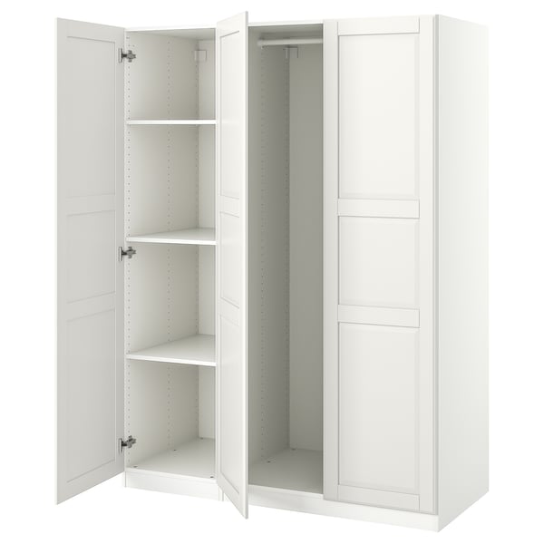 A white ikea PAX wardrobe with open doors, revealing empty shelves and storage space inside.