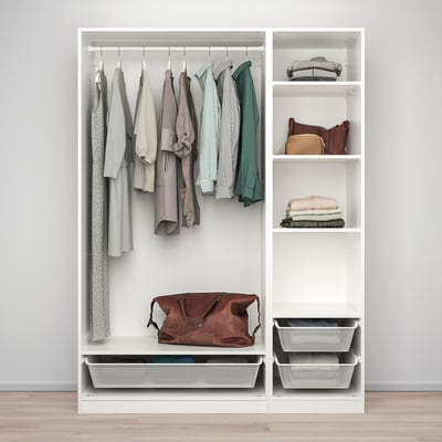 A white PAX wardrobe organizes clothes on hangers, shelves, and mesh bins, storing various garments and accessories neatly.