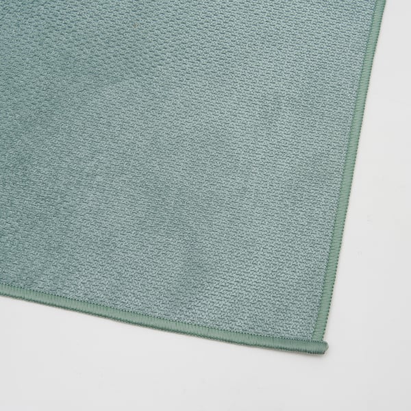 Green microfibre cloth, clean and neatly folded, showcasing quality texture.