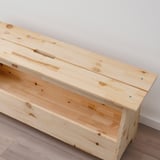 Wooden bench, light pine finish, sturdy construction, simple design, rectangular shape, two visible bolts.