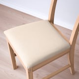 Image shows a high-quality light-colored wood chair with a beige upholstered seat. The craftsmanship highlights smooth edges and sturdy construction.