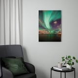 Modern living room with PJÄTTERYD aurora print, green chair, side table, plant, book, and cup.