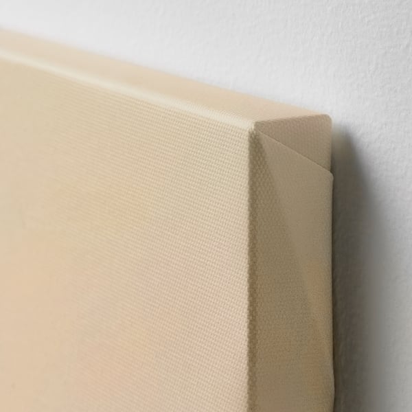 Art canvas close-up, showing smooth fabric and neat corners. Wrapped canvas edges visible.