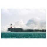 PJÄTTERYD canvas print, white, square, lighthouse, rocky wall, stormy waves, cloudy sky.