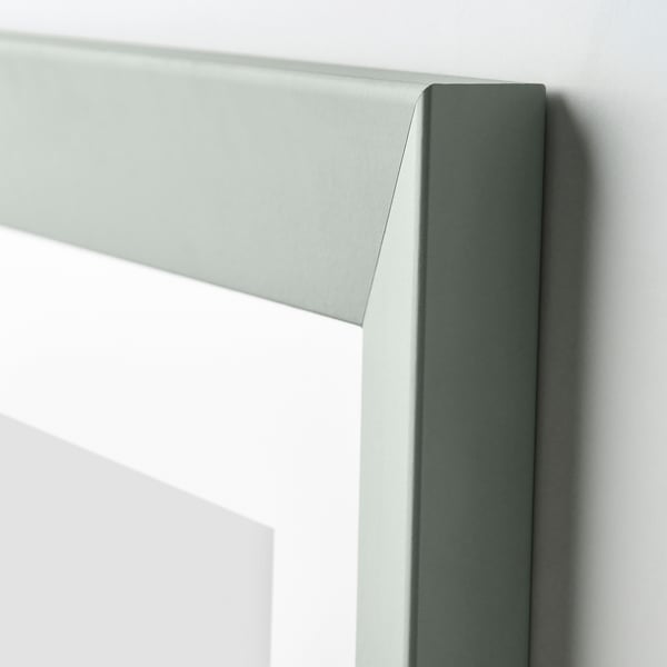 A close-up of a light green wooden frame, showing its smooth finish and sturdy design.