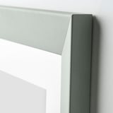 A close-up of a light green wooden frame, showing its smooth finish and sturdy design.