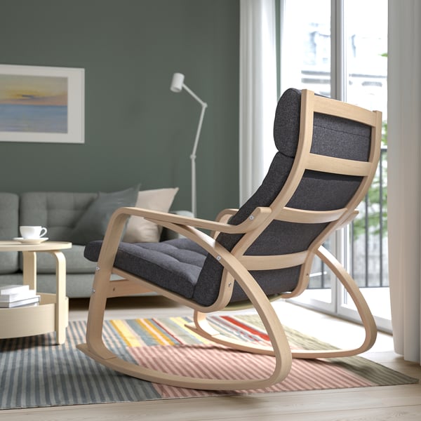 Comfortable rocking chair with curved wooden frame and cushioned seat, ideal for relaxing in a cozy living room.