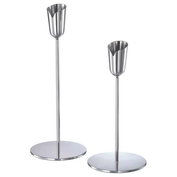 Two silver metal candlesticks with round bases and trumpet-shaped holders. Sleek, modern design. Ideal for decor.