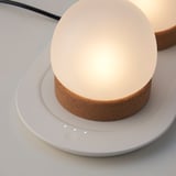 Close-up of a glass and cork table lamp, part of a trio, showcasing its high-quality, minimalist design.