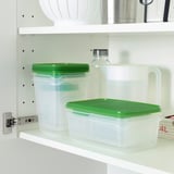 White shelf with clear plastic containers, green lids, and water jug. Stackable for space efficiency.