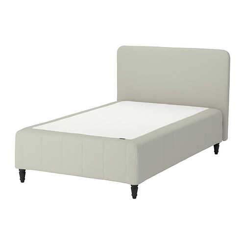 A RÅHOLMAR bed in white, featuring a padded headboard and dark wooden legs.