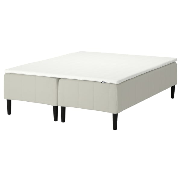 White RÅHOLMAR mattress base, modern design with 4 wooden legs, upholstered in fabric.