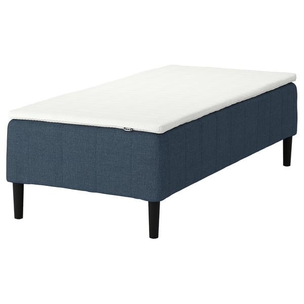 IKEA blue and white RÅHOLMAR mattress on dark blue fabric base, rectangular and simple design.