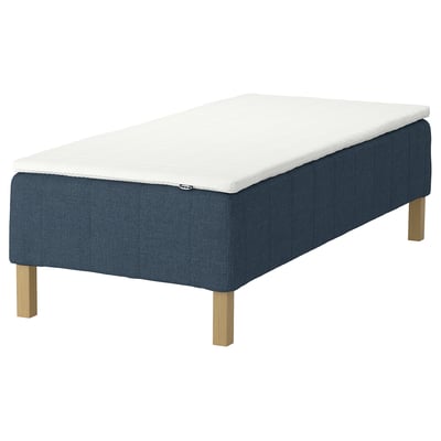 The RÅHOLMAR mattress: dark blue and white, rectangular, with wooden legs.