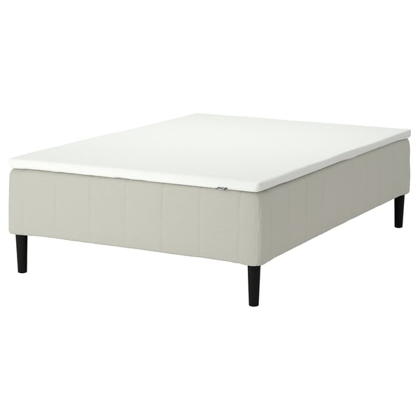 The RÅHOLMAR bed base in white with black legs, featuring a 5-zone mattress for spine alignment.