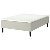 The RÅHOLMAR bed base in white with black legs, featuring a 5-zone mattress for spine alignment.