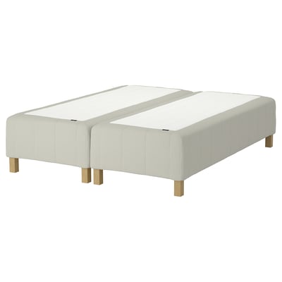 The RÅHOLMAR bed base 2 white, upholstered sections with wooden legs, a modern minimalist design for comfort.