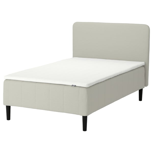 IKEA RÅHOLMAR: cream, upholstered bed with 5 comfort zones, dark wooden legs, sleek modern design.