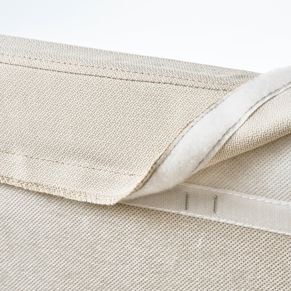 Beige bed cover with mesh panel and straps, designed for RAMNEFJÄLL bed, easy to remove and machine washable.