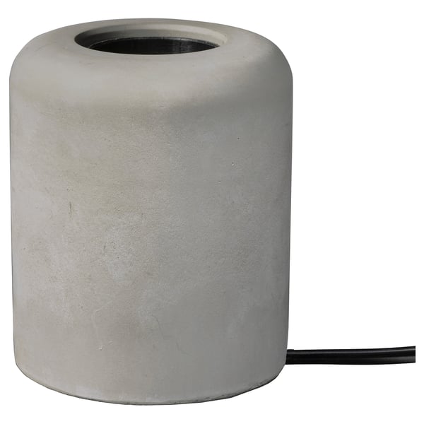 Depicts a minimalist gray concrete table lamp base named RÅSEGEL, designed to hold a decorative light bulb, providing a stable and heavy foundation.