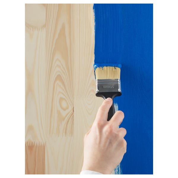 Hand painting wooden furniture blue, showing creative diy.