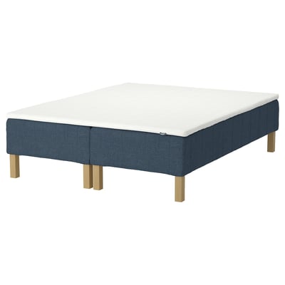 A blue RENFJÄLLET bed frame with a white mattress, raised on wooden legs.