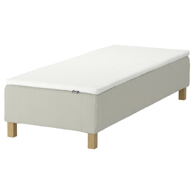 An IKEA RENFJÄLLET white mattress with wooden legs, featuring a minimalist design for comfort and ease of cleaning.