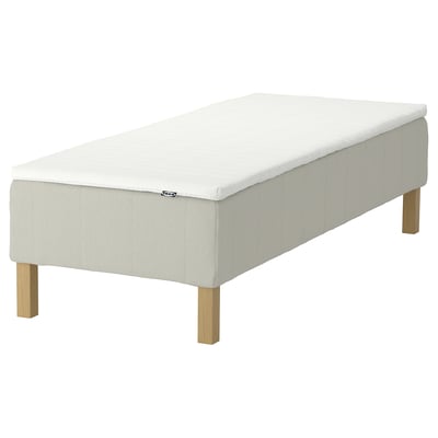 IKEA white rectangular bed with wooden legs and pocket springs.
