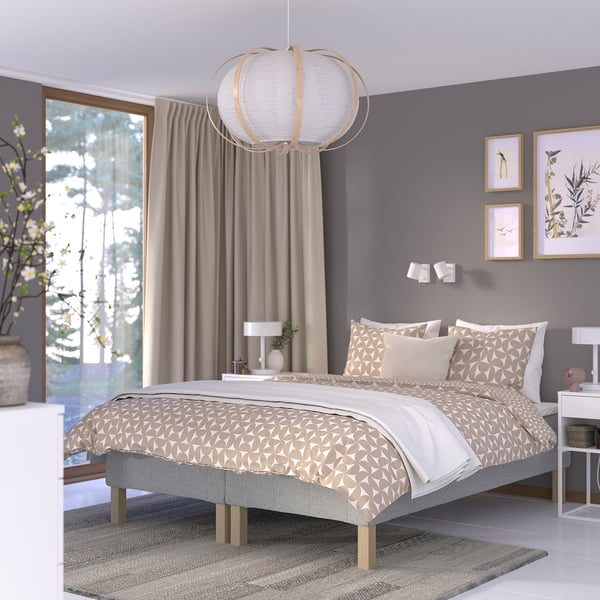 Modern bedroom with RENFJÄLLET bed, grey theme, pendant lamp, and large plant.