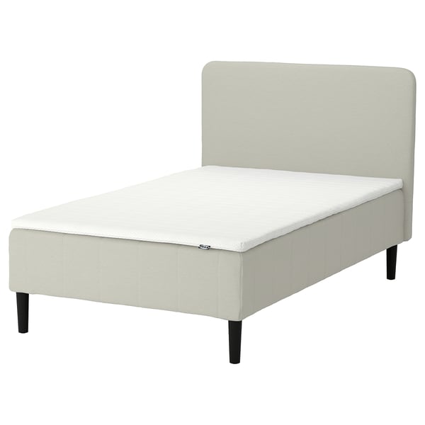 The RENFJÄLLET bed in light beige, featuring a pocket spring mattress, upholstered headboard, and wooden legs.