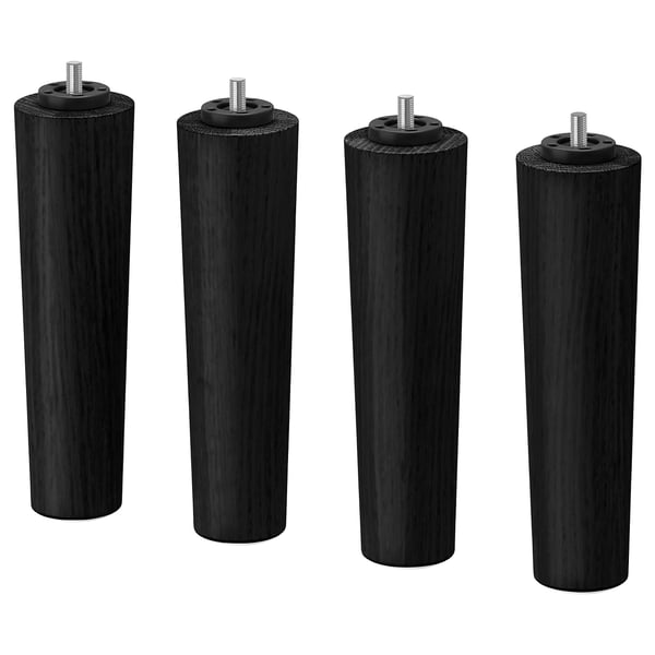 Four black wooden legs with metal screws for furniture.