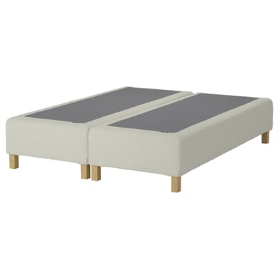 A cream-colored RENFJÄLLET bed base with wooden legs; it has a modern, minimalist design.