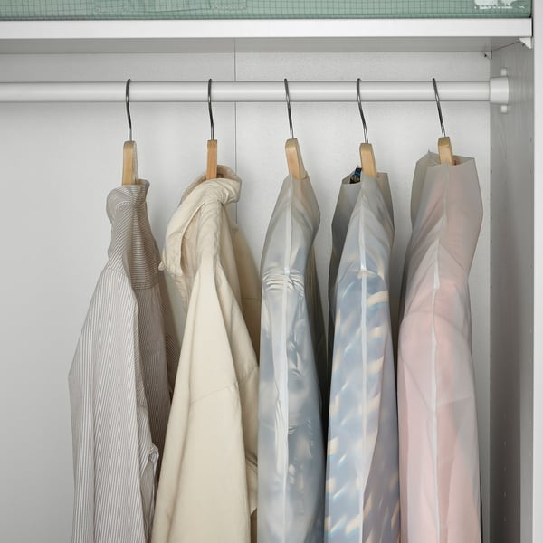 Clothes covers in closet protect garments from dust. Hang delicate items neatly.
