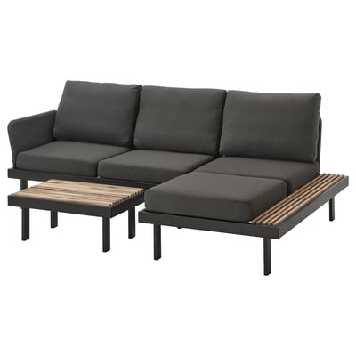 Black outdoor sofa set with cushions and slatted tables. Modern, l-shaped design.