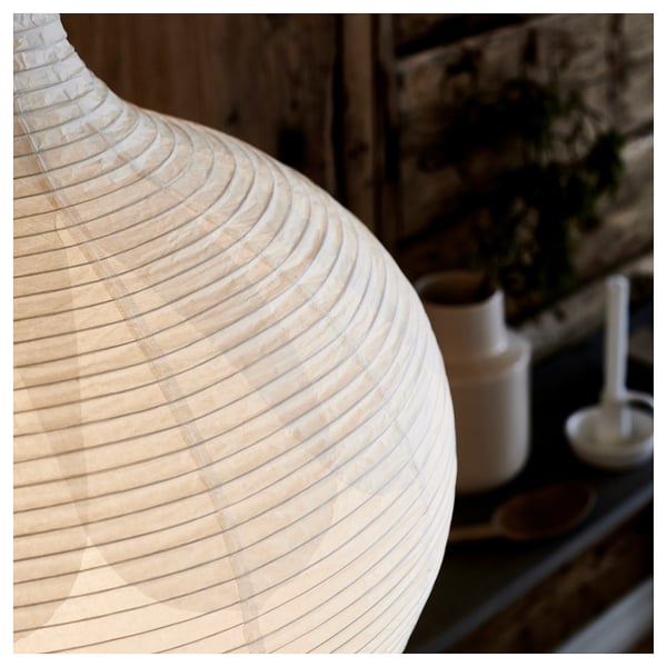 A risbyon lamp with light birch veneer and rice paper shade. The lamp has a cylindrical base and a rounded shade, creating a soft, warm light.