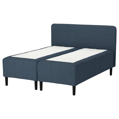 The RISHÖJDEN bed is blue, with a fabric headboard, white mattress, dark wooden legs, and a rectangular design.