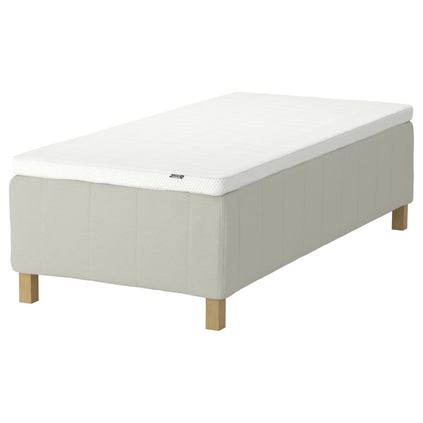 An off-white RISHÖJDEN mattress with wooden legs, showcasing a minimalist and modern design.