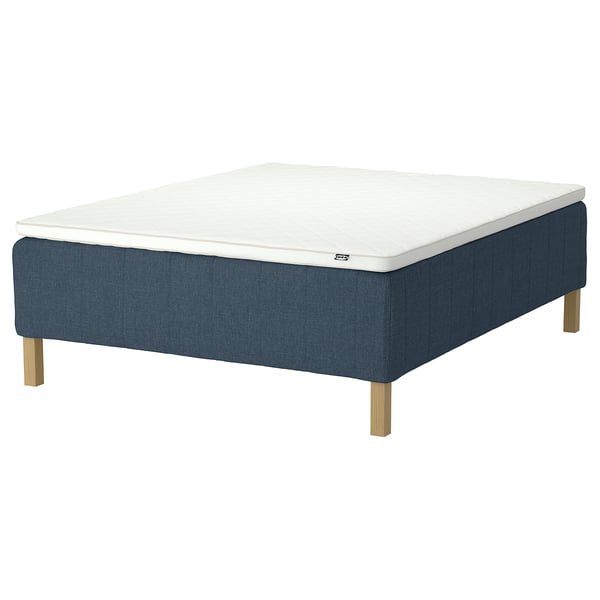 Blue upholstered bed frame with white mattress, square wooden legs.