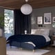 Modern bedroom with wooden ceiling, dark grey walls, blue chequered bed, white pillows, hanging lamp, dark blue curtains, and wall art.