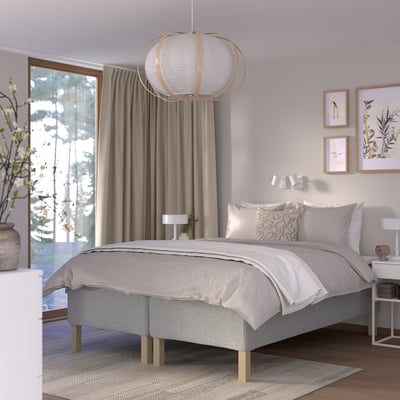 Modern bedroom with grey RISHÖJDEN bed, soft mattress, large window, pendant light, art, plant.
